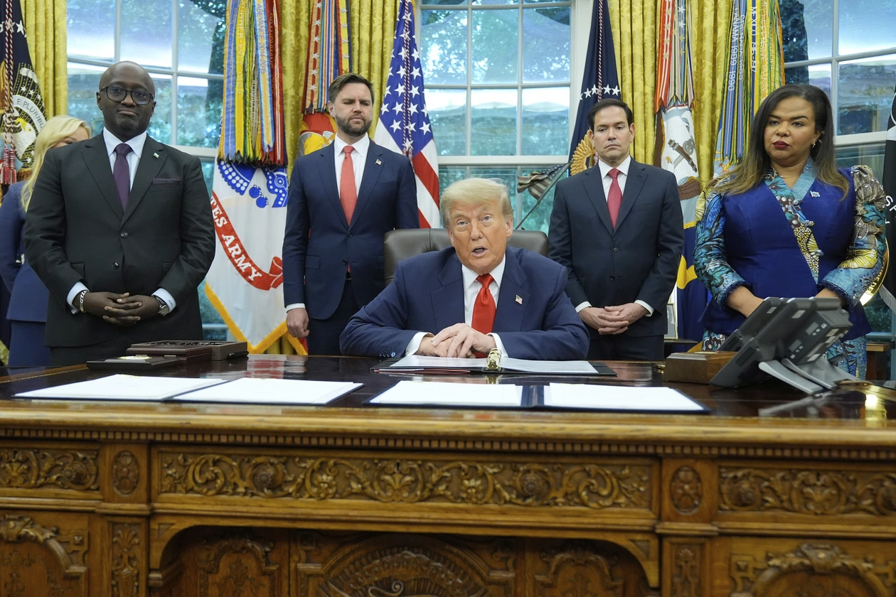 President Donald Trump with Congo's Foreign Minister Therese Kayikwamba Wagner and Rwanda's Foreign Minister Olivier Nduhungirehe at the White House in June, as Vice President JD Vance and Secretary of State Marco Rubio watch. | Manuel Balce Ceneta/AP