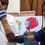 Gift Usen, 25, born handicapped, tries on a bionic prosthetic arm at Immortal Cosmetic Art laboratory in Uyo, Akwa Ibom state, Nigeria, August 16, 2025. REUTERS/Sodiq Adelakun